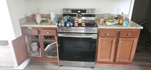 a kitchen with stainless steel appliances granite countertop a stove and cabinets