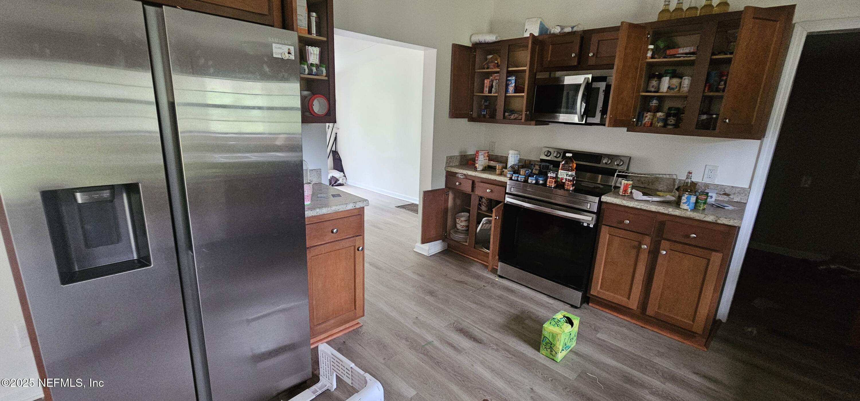 5951 Westwood Road North Jacksonville, FL 32234 - Photo 19 of 33 a kitchen with stainless steel appliances a refrigerator and a stove top oven