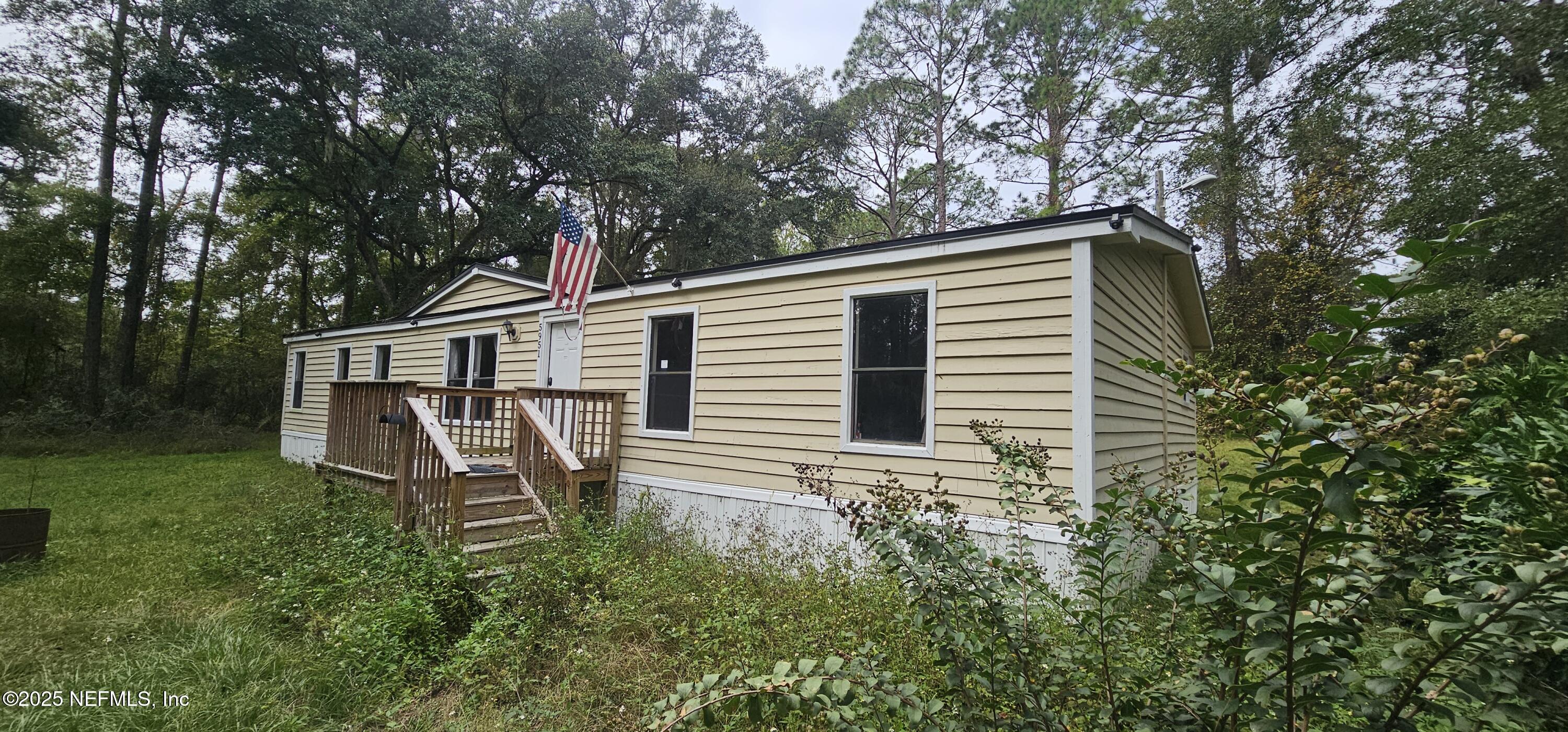 5951 Westwood Road North Jacksonville, FL 32234 - Photo 2 of 33 a backyard of a house with table and chairs