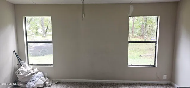 a room with a window and bed