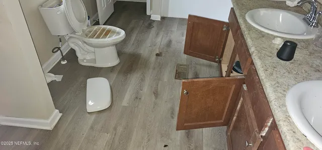 a bathroom with a sink toilet and mirror