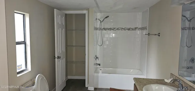 a bathroom with a bathtub and shower