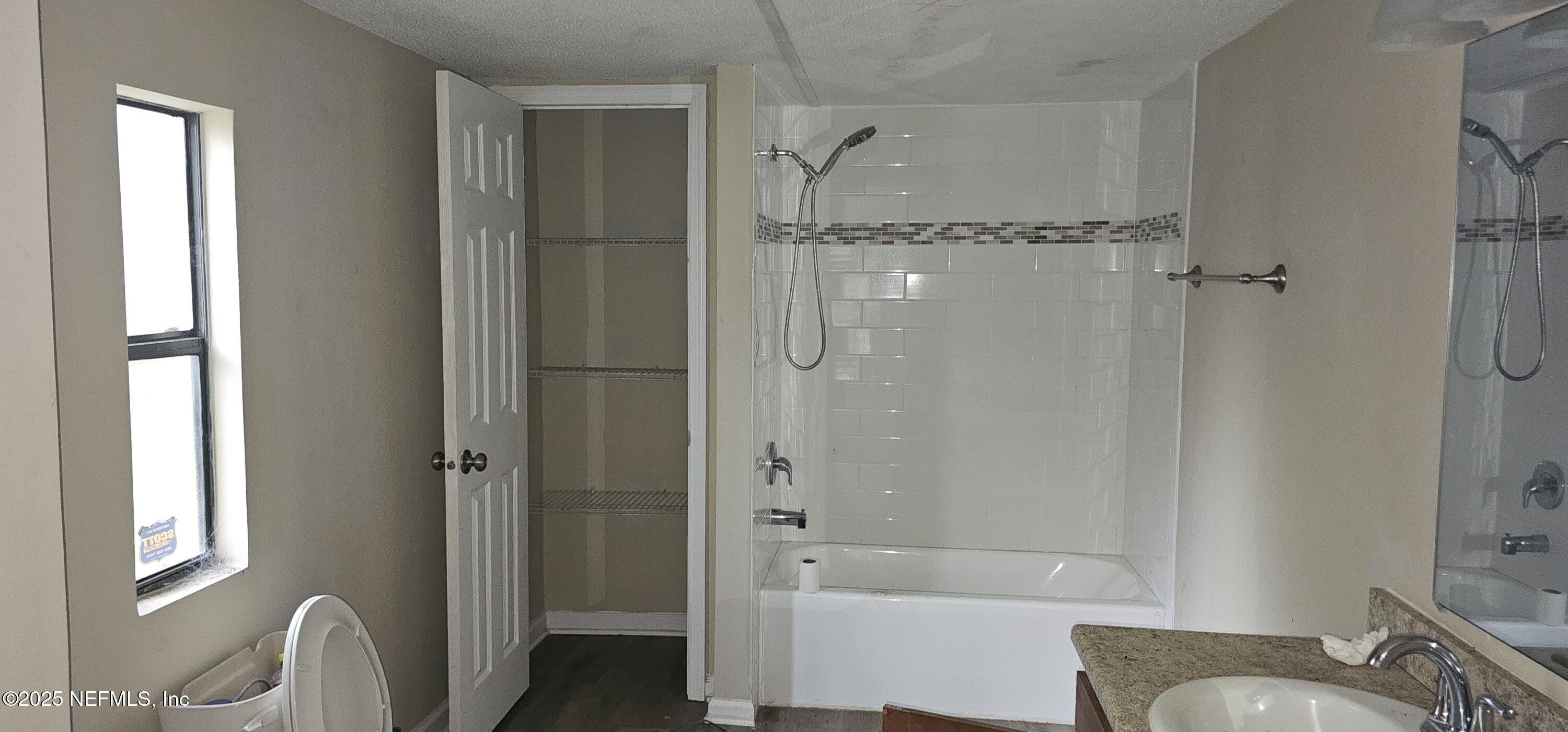 5951 Westwood Road North Jacksonville, FL 32234 - Photo 23 of 33 a bathroom with a bathtub and shower