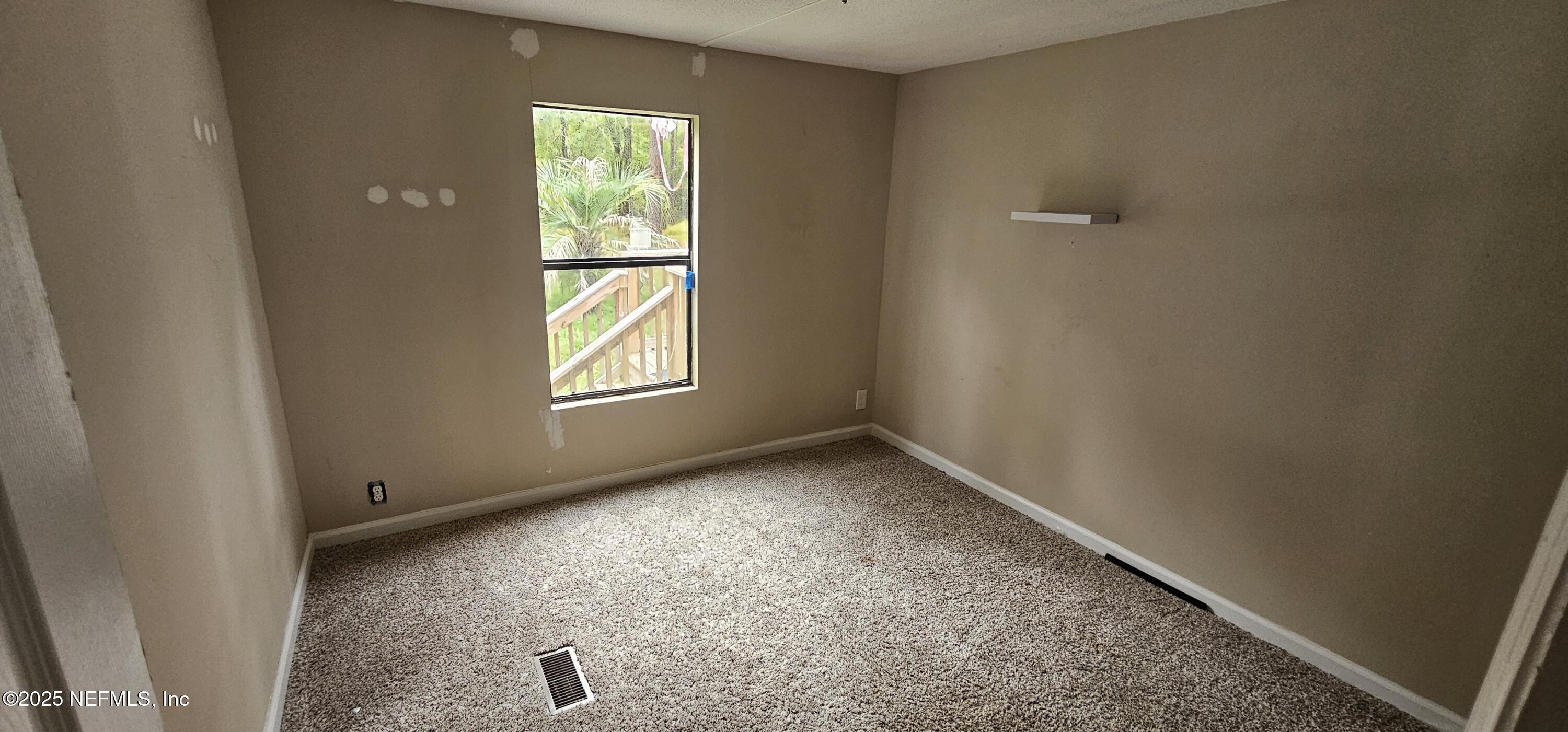 5951 Westwood Road North Jacksonville, FL 32234 - Photo 7 of 33 an empty room with windows