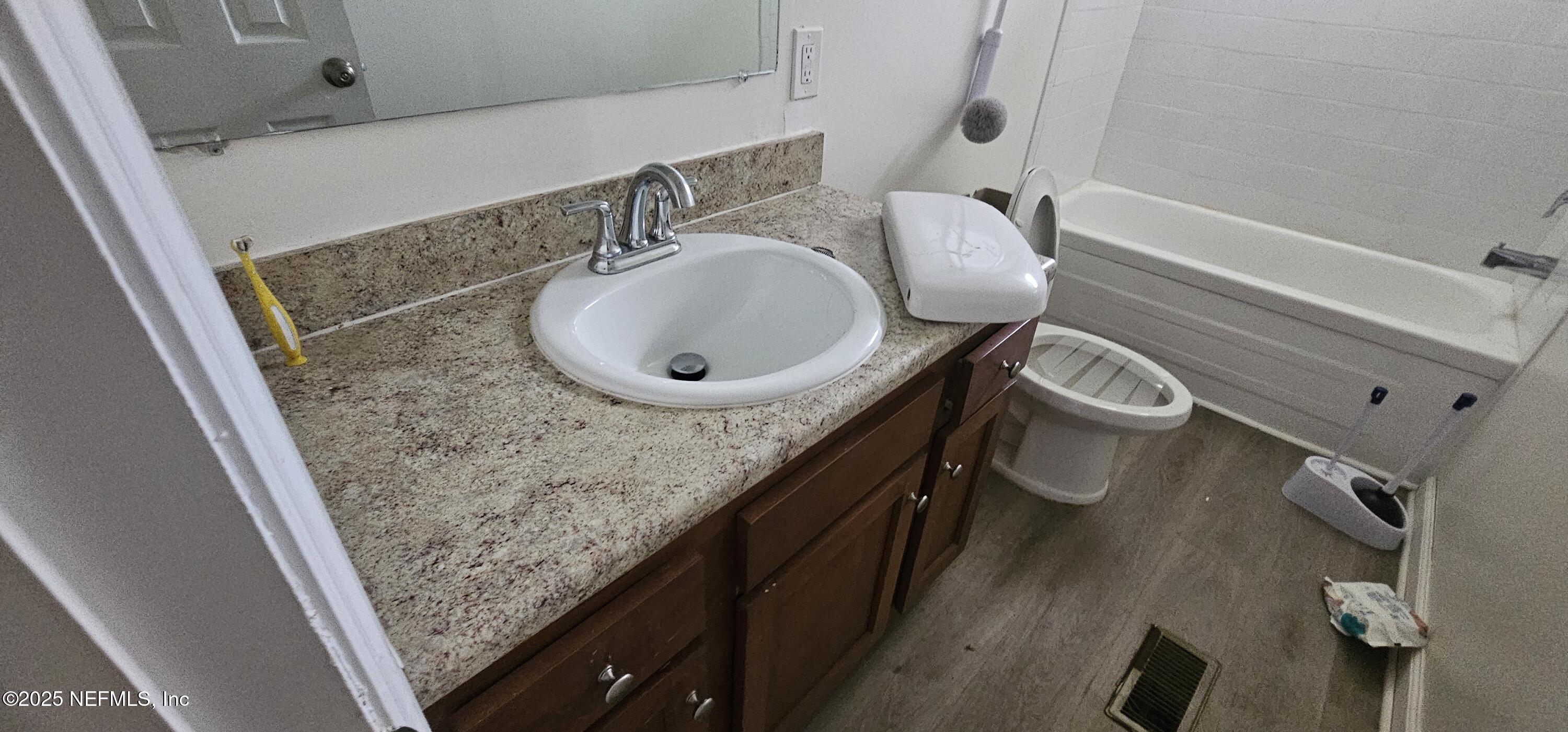 5951 Westwood Road North Jacksonville, FL 32234 - Photo 10 of 33 a bathroom with a granite countertop sink a mirror and shower