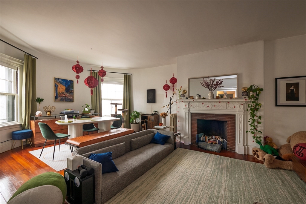 11 Wayne Street Boston, MA 02121 - Photo 20 of 27 a living room with furniture and a fireplace