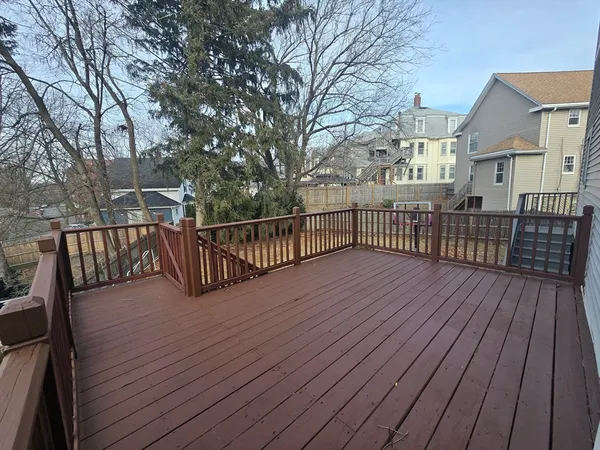 a view of deck with wooden floor and fence