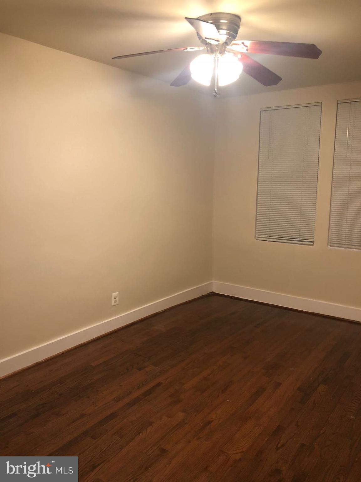 1918 I Street Northeast Washington, DC 20002 - Photo 15 of 29 a view of an empty room with wooden floor and a fan