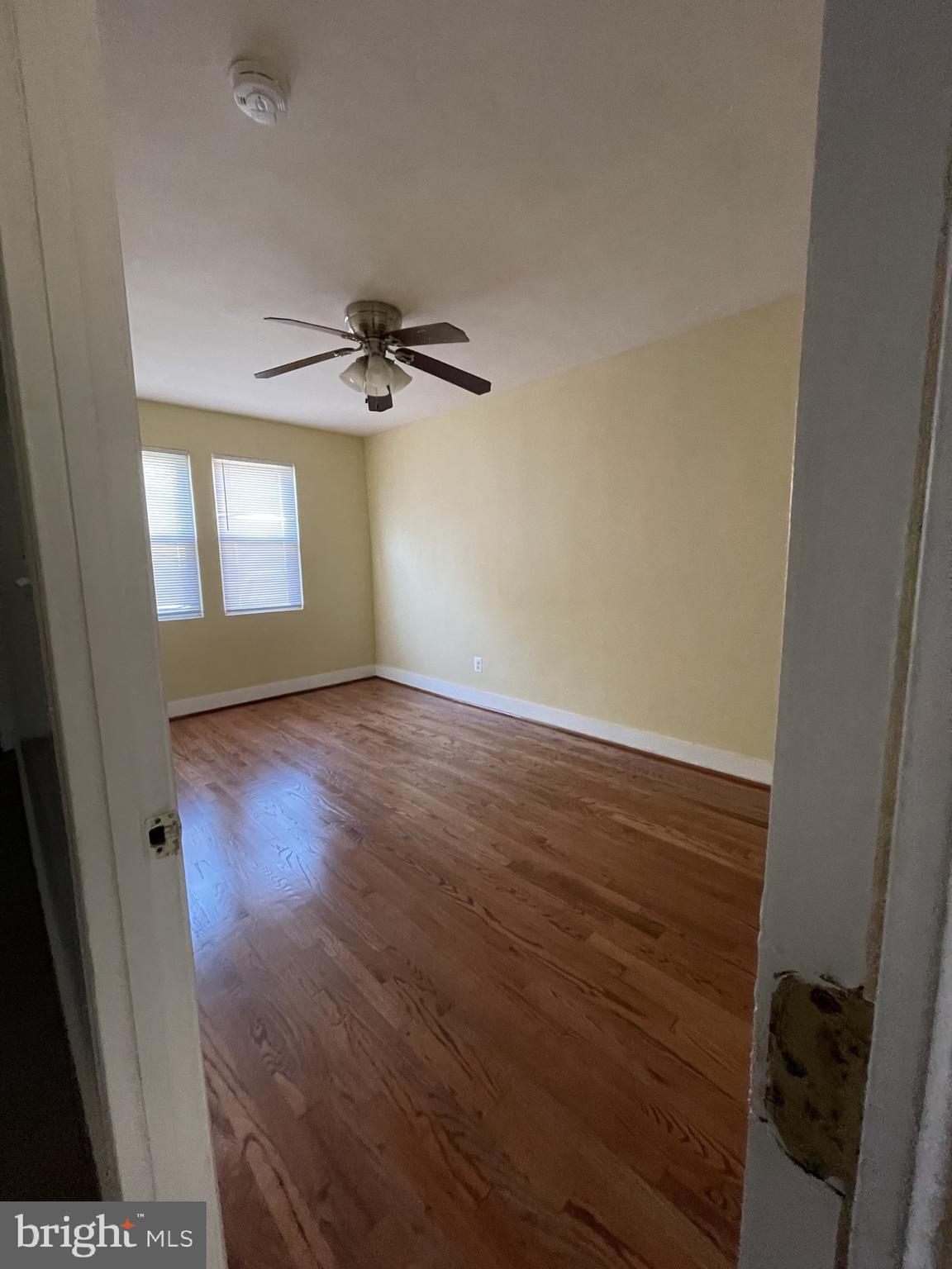 1918 I Street Northeast Washington, DC 20002 - Photo 19 of 29 an empty room with wooden floor and windows