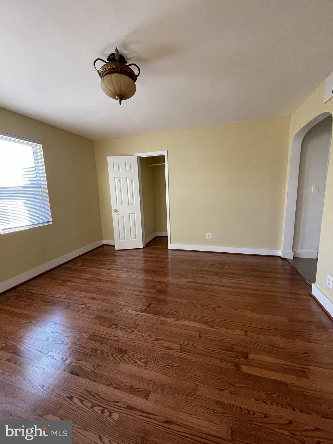 1918 I Street Northeast Washington, DC 20002 - Photo 23 of 29 an empty room with wooden floor and windows