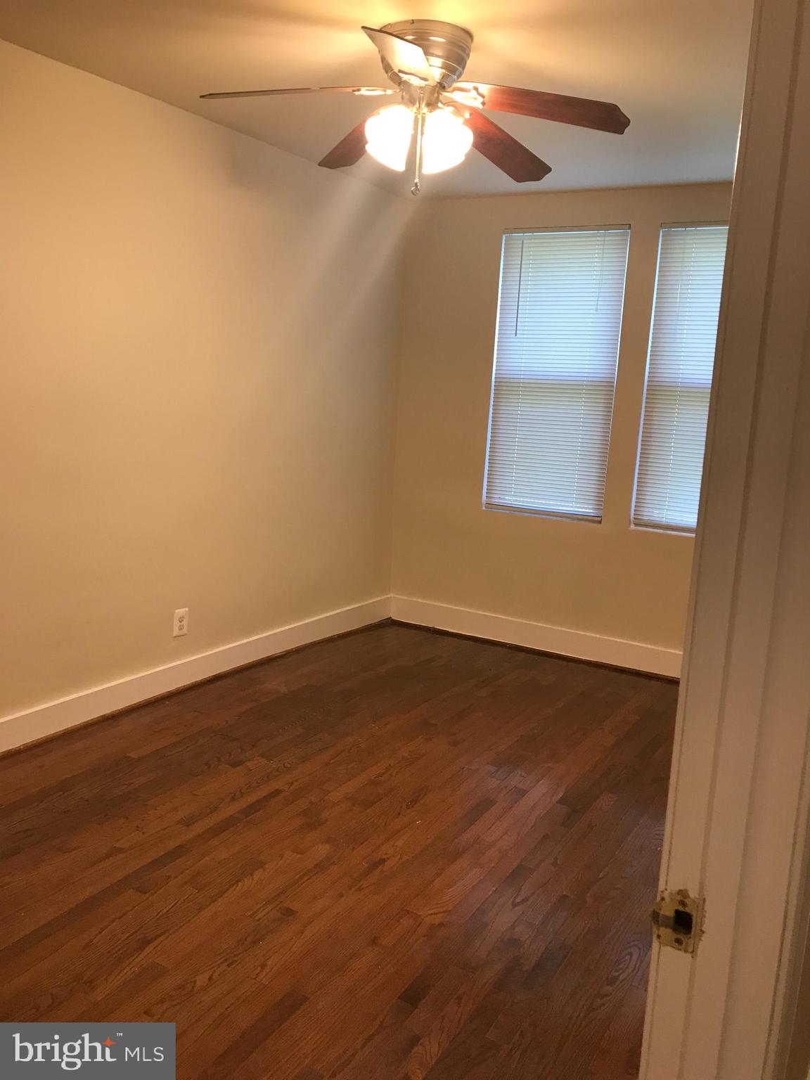 1918 I Street Northeast Washington, DC 20002 - Photo 7 of 29 a view of an empty room with wooden floor and a window