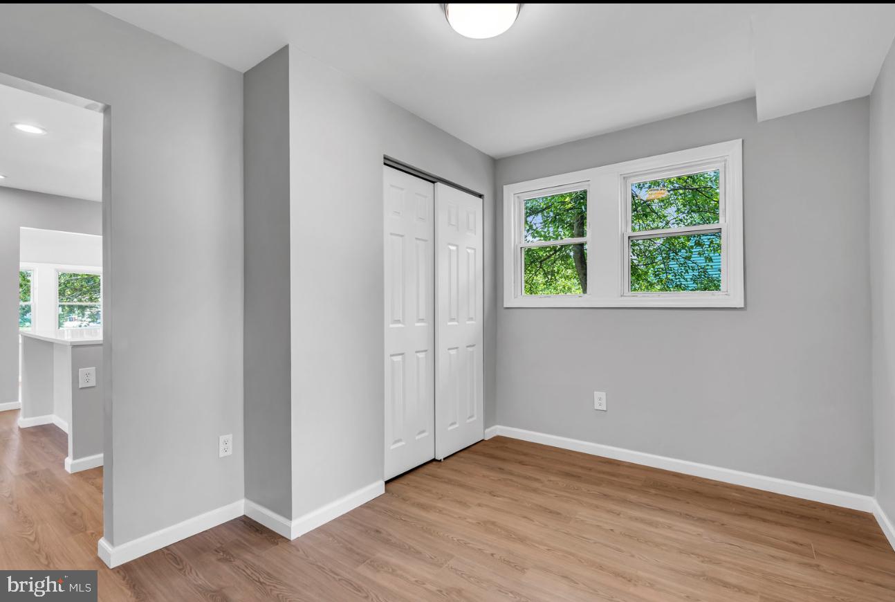 239 West Evesham Road Runnemede, NJ 08078 - Photo 16 of 31 an empty room with wooden floor and windows
