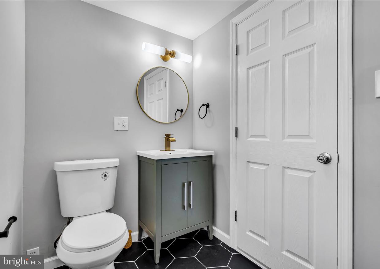 239 West Evesham Road Runnemede, NJ 08078 - Photo 17 of 31 a bathroom with a toilet a sink and mirror
