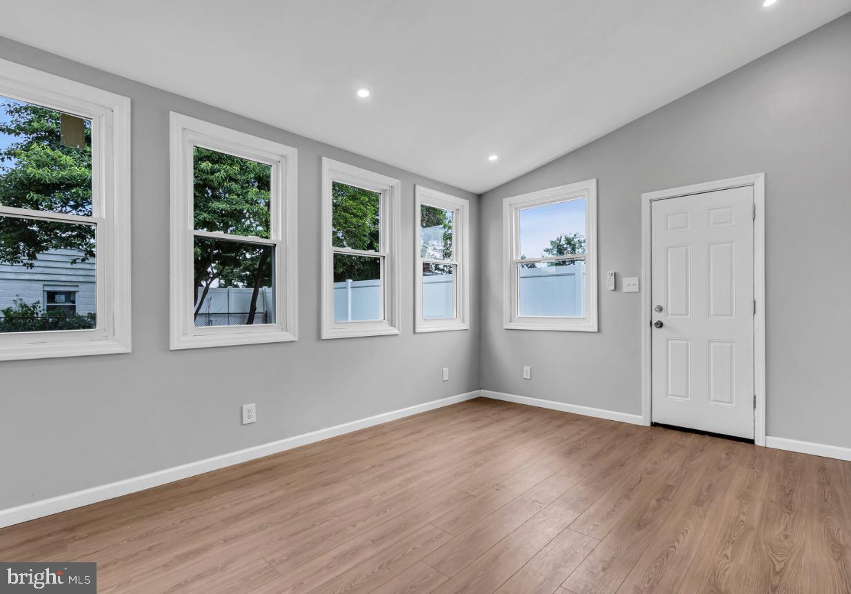 239 West Evesham Road Runnemede, NJ 08078 - Photo 18 of 31 a view of an empty room with wooden floor and a window