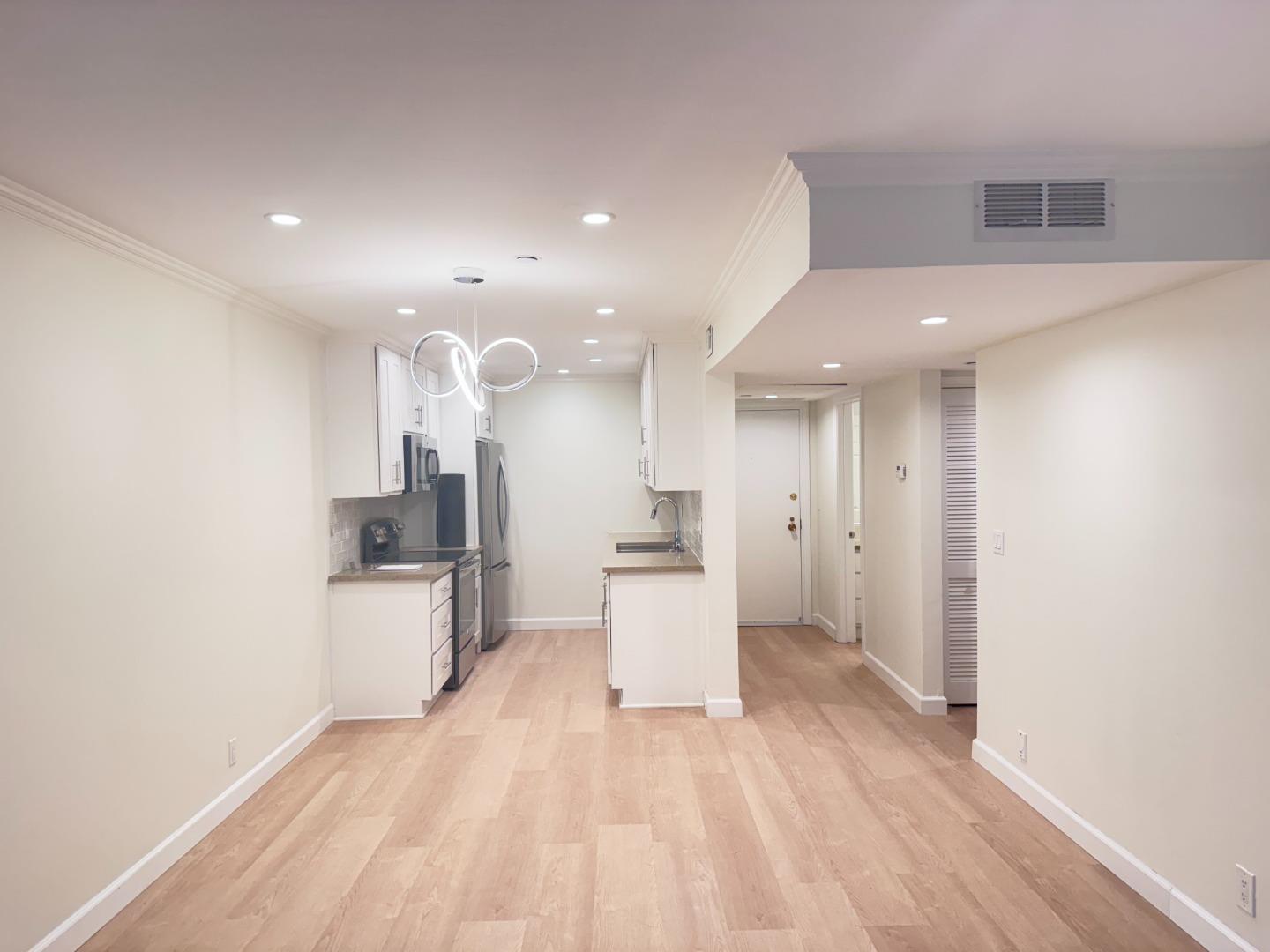 101 2nd Street, Unit 5 Los Altos, CA 94022 - Photo 12 of 48 a open kitchen with white cabinets and stainless steel appliances