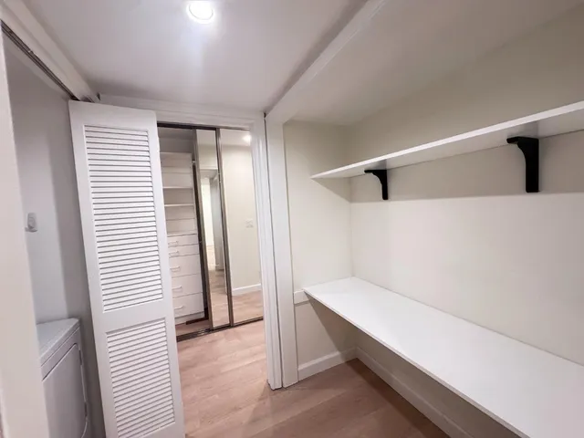 a view of a room with a window and a door