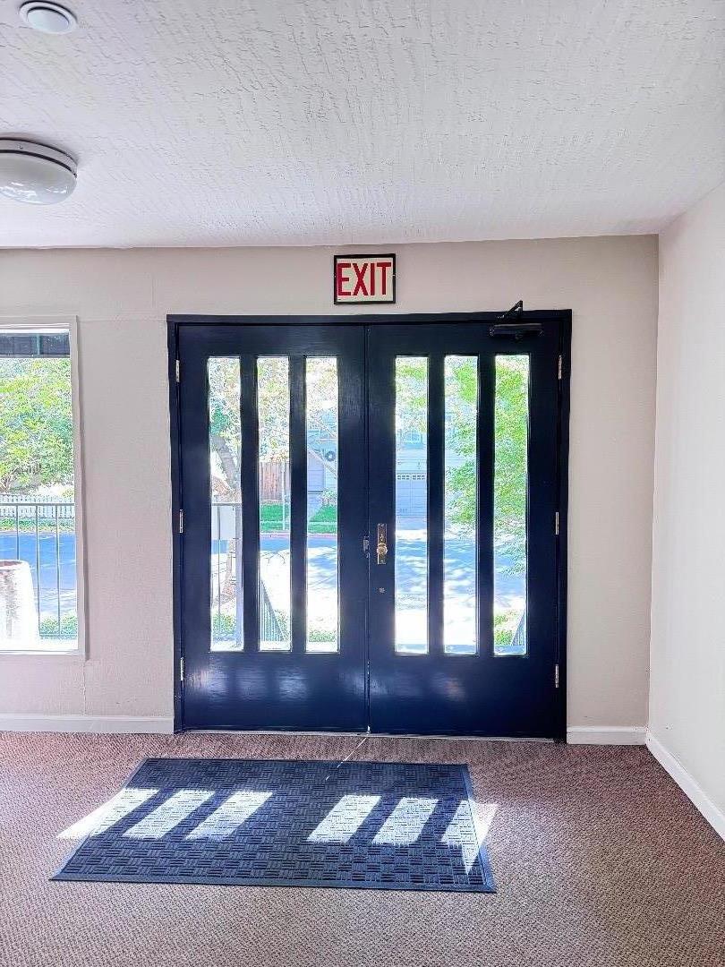 101 2nd Street, Unit 5 Los Altos, CA 94022 - Photo 29 of 48 a view of an empty room with wooden floor and a window