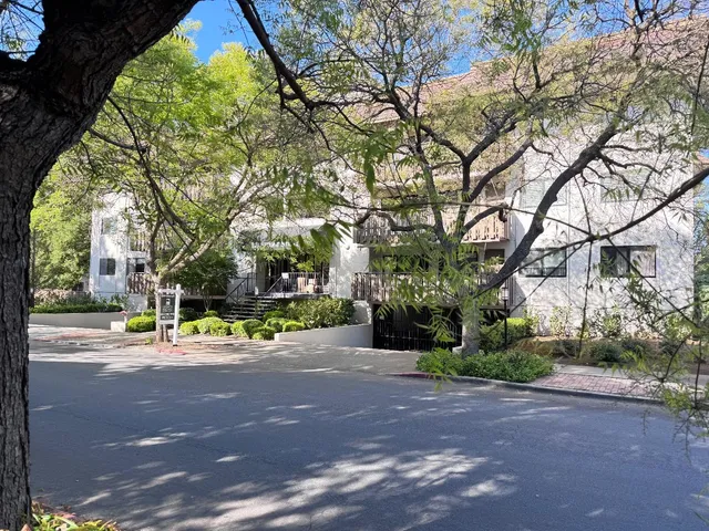 a view of a building with large trees