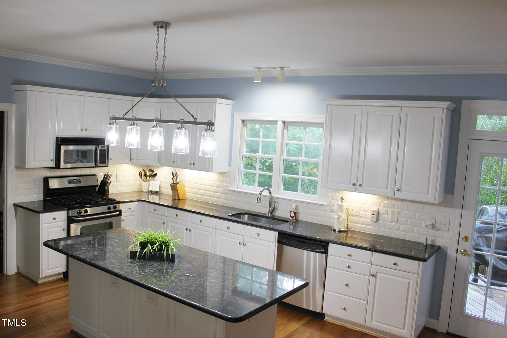 3100 Anderson Drive Raleigh, NC 27609 - Photo 11 of 31 a kitchen with stainless steel appliances granite countertop a sink a stove and a wooden floors
