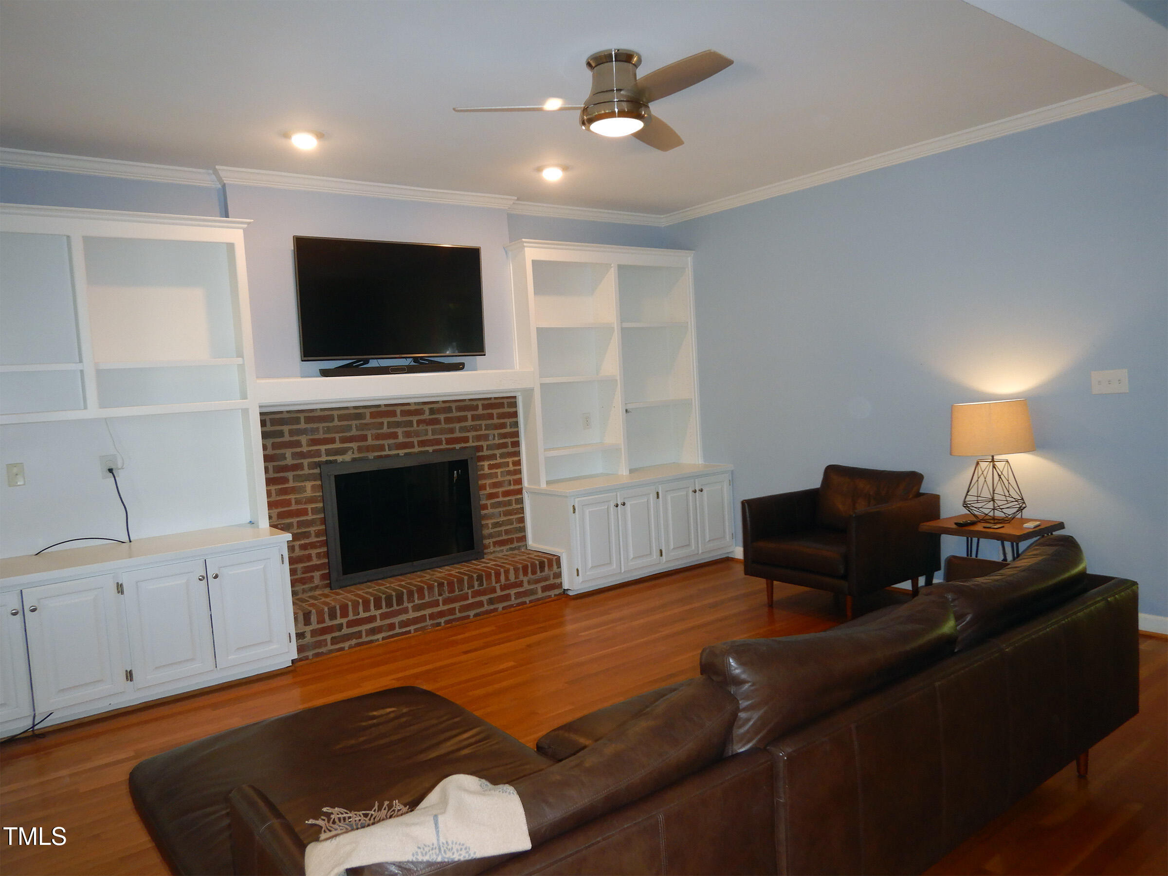 3100 Anderson Drive Raleigh, NC 27609 - Photo 14 of 31 a living room with furniture a flat screen tv and a fireplace
