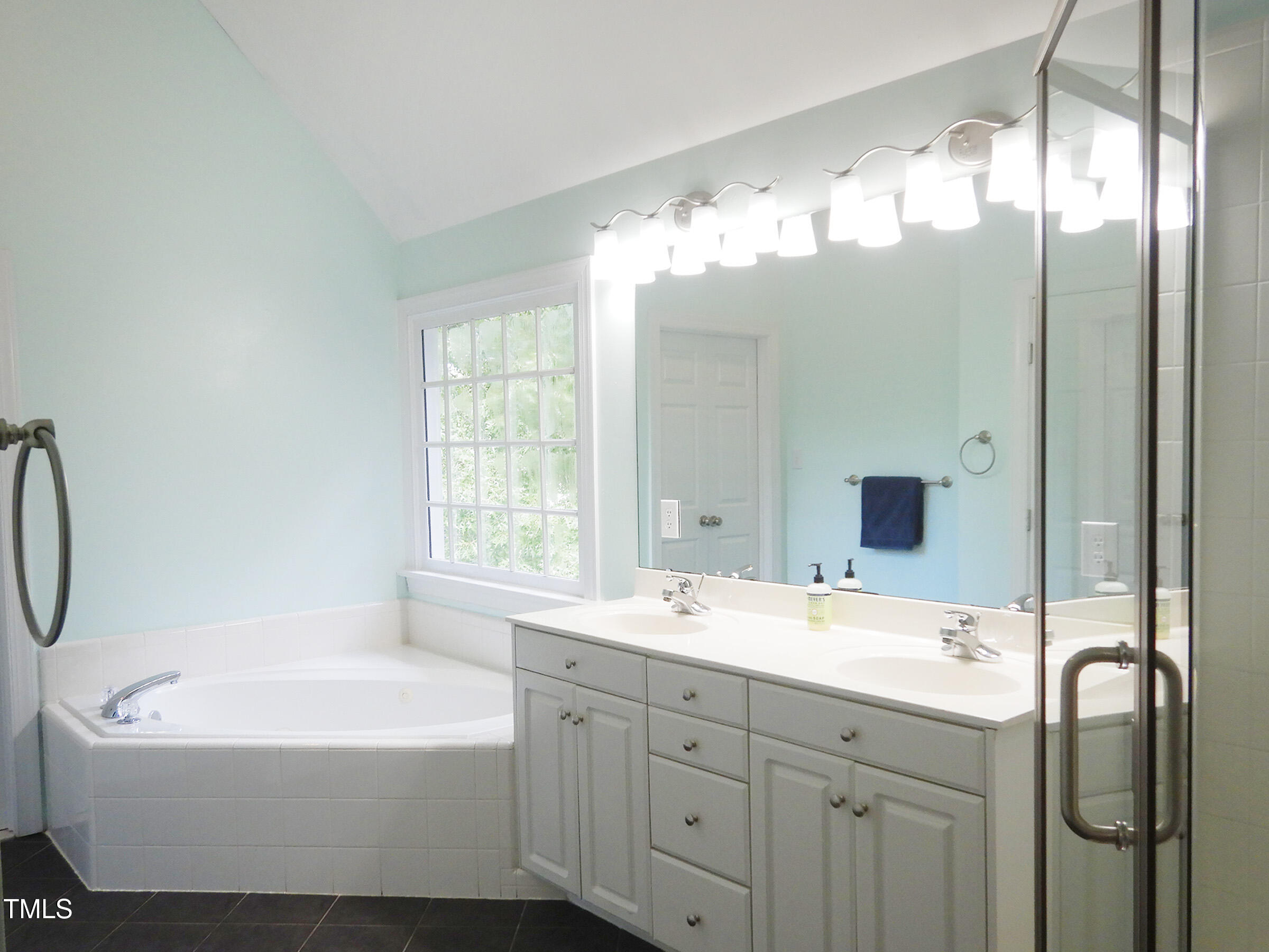 3100 Anderson Drive Raleigh, NC 27609 - Photo 19 of 31 a bathroom with a bathtub sink and mirror