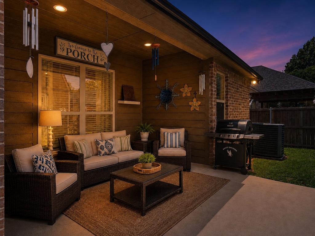 701 West Lamberth Road Sherman, TX 75092 - Photo 31 of 37 Covered patio featuring a concrete slab, recessed ceiling lighting, a textured brown exterior wall, a brick exterior wall, and a grass area