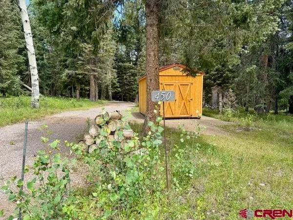 a backyard of a house with a yard and outdoor seating