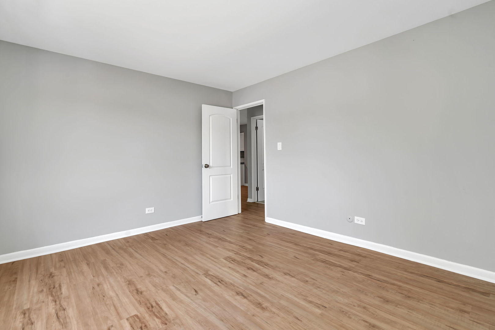 909 Plainfield Road, Unit 12 Darien, IL 60561 - Photo 9 of 10 a view of an empty room with wooden floor