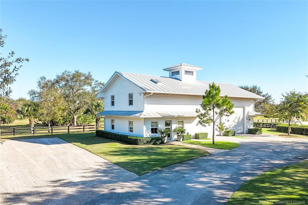 2541 Southwest Trailside Path Stuart, FL 34997 - Photo 63 of 100 a view of a house with a big yard plants and large trees