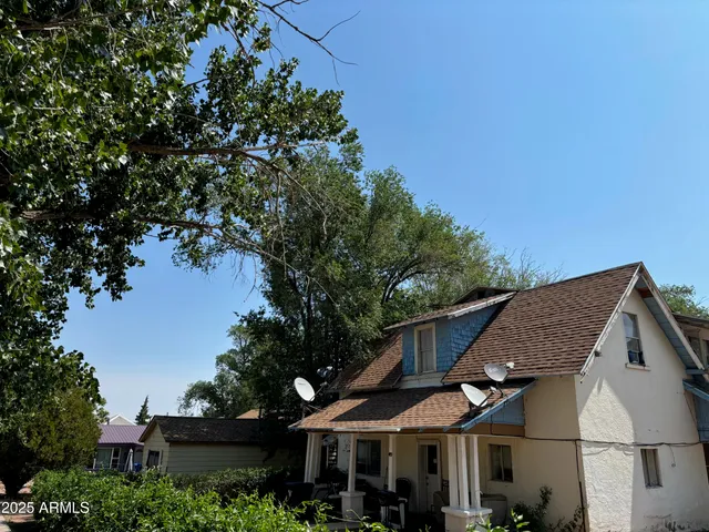 a front view of a house with a tree
