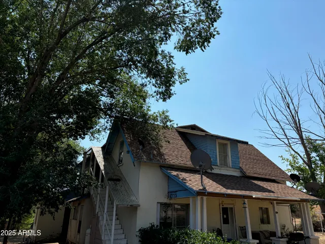 a backyard of a house with table and chairs