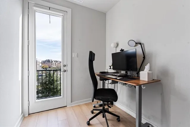 a view of workspace with wooden floor windows