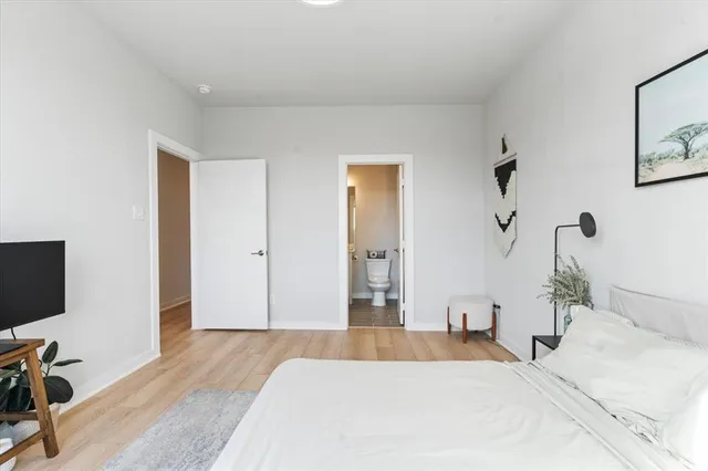 a bedroom with a bed and window