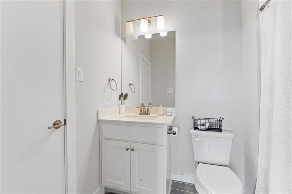 2268 Rook Drive Dallas, TX 75211 - Photo 8 of 19 a bathroom with a toilet sink and mirror