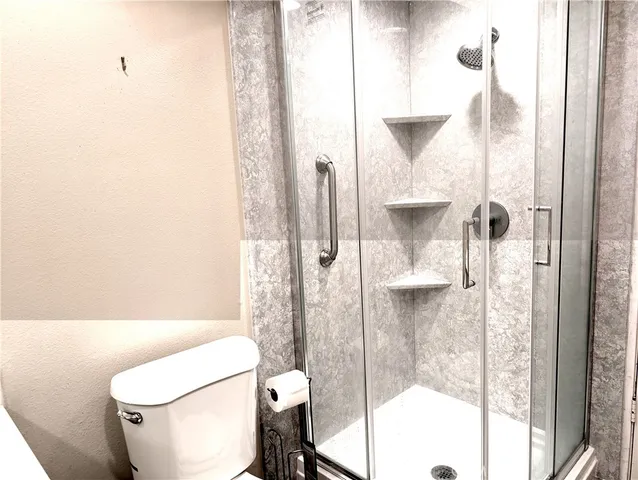 a bathroom with a toilet and shower