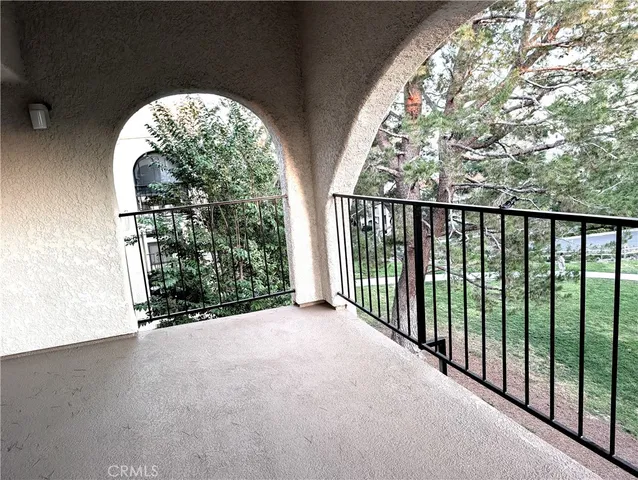 a picture of a yard with table and chairs plants and trees