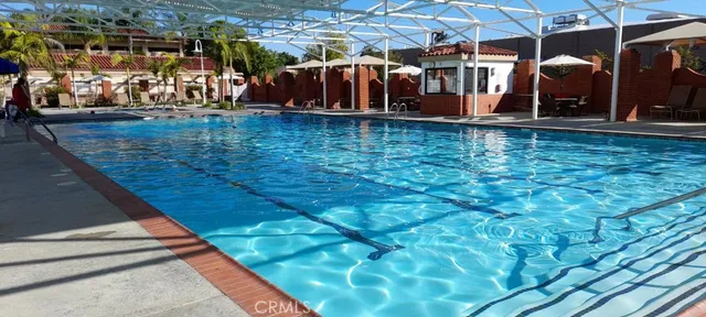 a view of a tennis court with lots of trees in the background