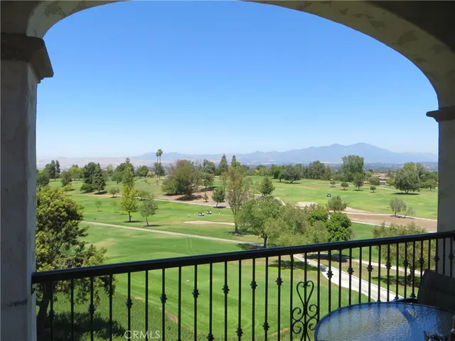 a group of people sitting on a deck in front of building