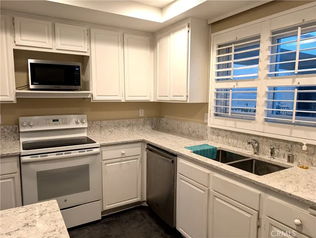 a kitchen with a sink and a microwave