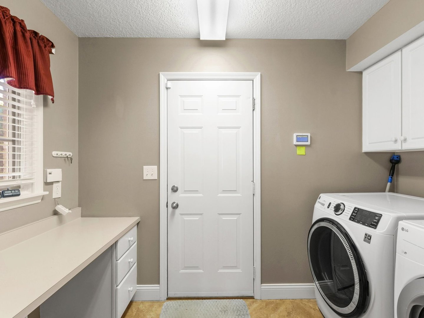 1901 Lakeside Drive, Unit B Champaign, IL 61821 - Photo 21 of 26 a bathroom with a sink a washer and dryer