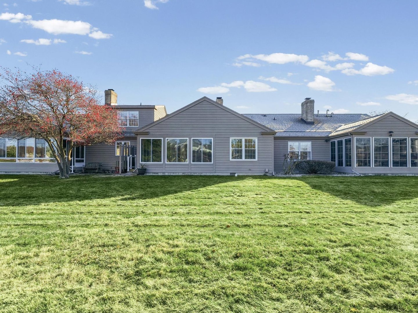 1901 Lakeside Drive, Unit B Champaign, IL 61821 - Photo 23 of 26 a front view of a house with a yard table and chairs
