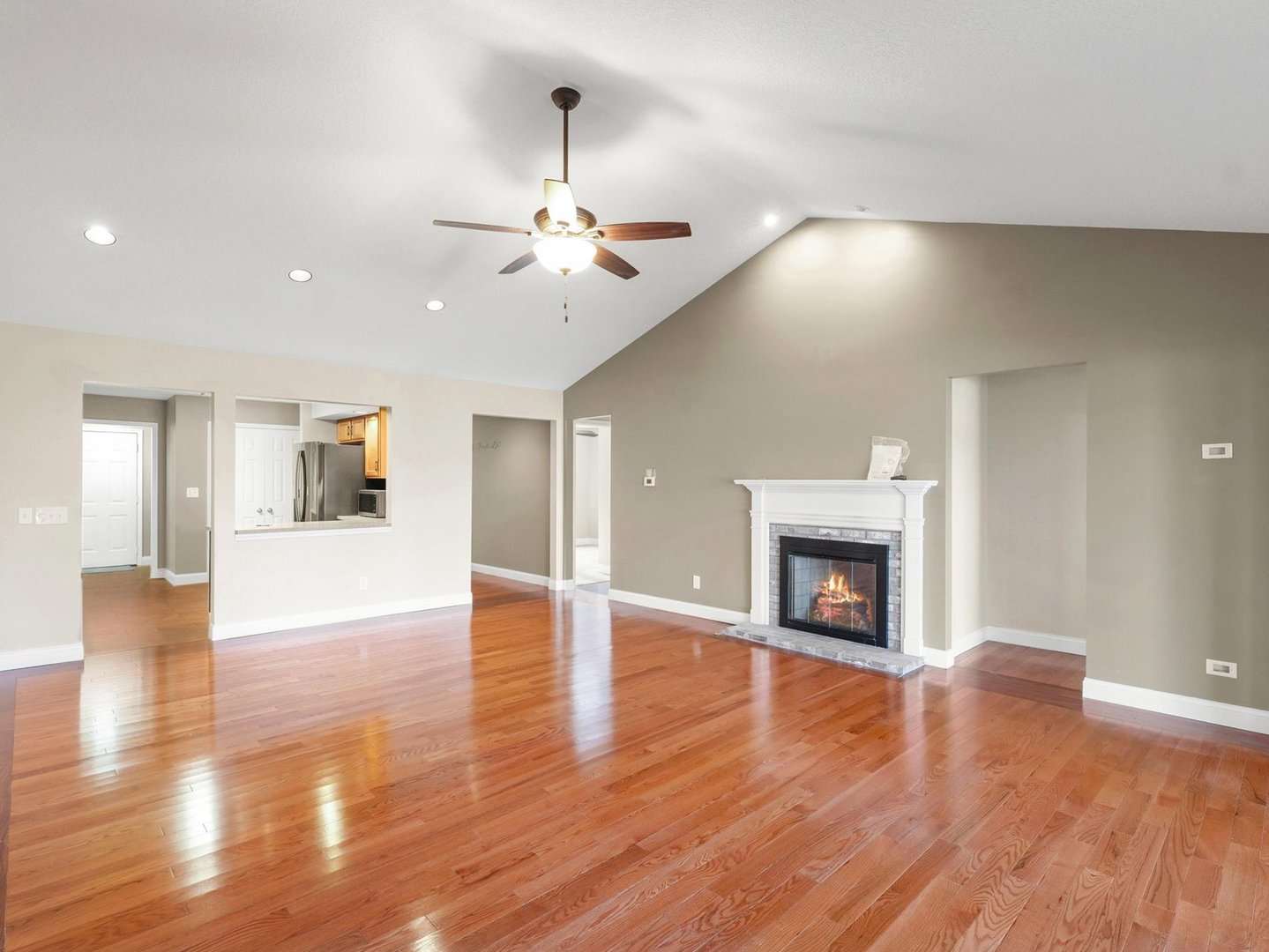 1901 Lakeside Drive, Unit B Champaign, IL 61821 - Photo 5 of 26 a view of an empty room with wooden floor fireplace and a window