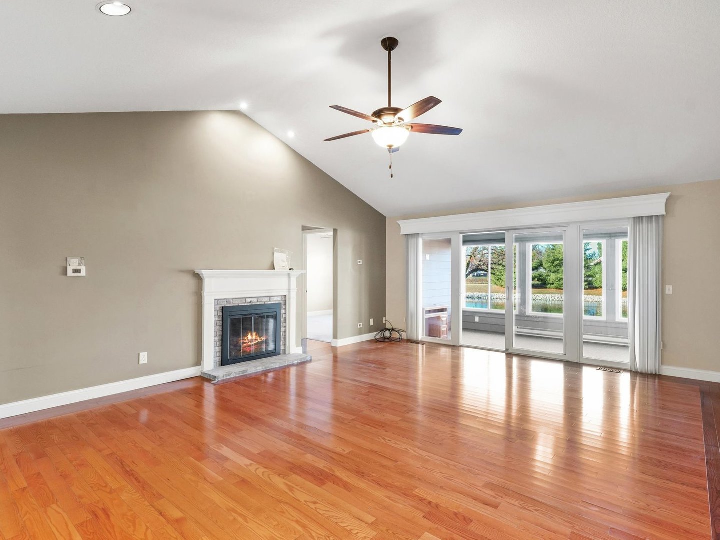 1901 Lakeside Drive, Unit B Champaign, IL 61821 - Photo 6 of 26 a view of an empty room with wooden floor and a window