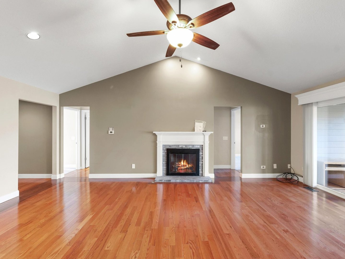 1901 Lakeside Drive, Unit B Champaign, IL 61821 - Photo 7 of 26 a view of an empty room with wooden floor fireplace and a window