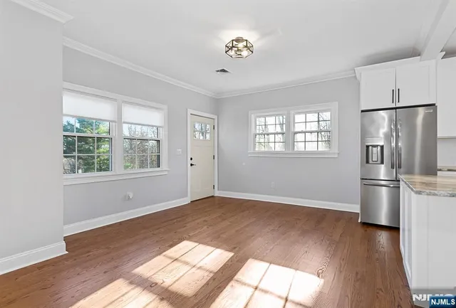 a view of a kitchen with wooden floor and a kitchen