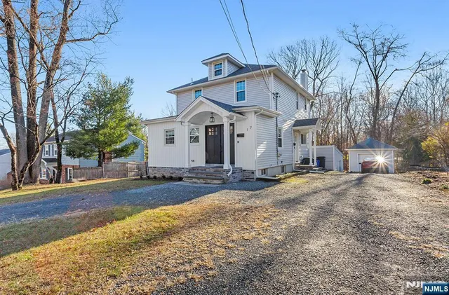a view of a house with a yard and garage