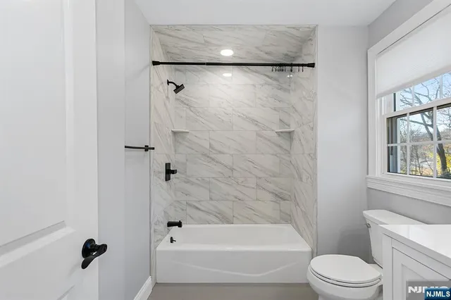 a bathroom with a shower and a toilet