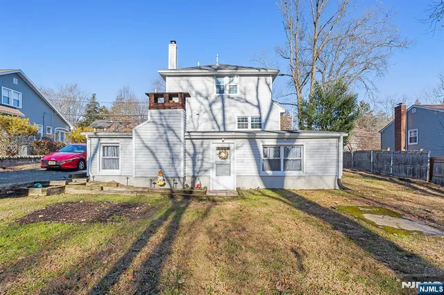a view of a house with a yard and sitting area