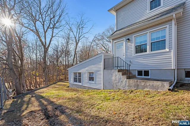 a view of a house with a yard covered in snow