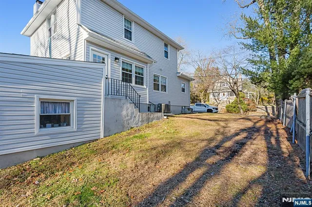 a view of the house with a yard